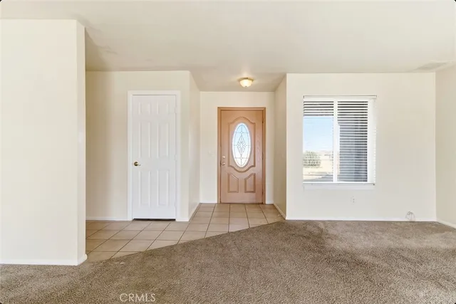an empty room with windows and mirror