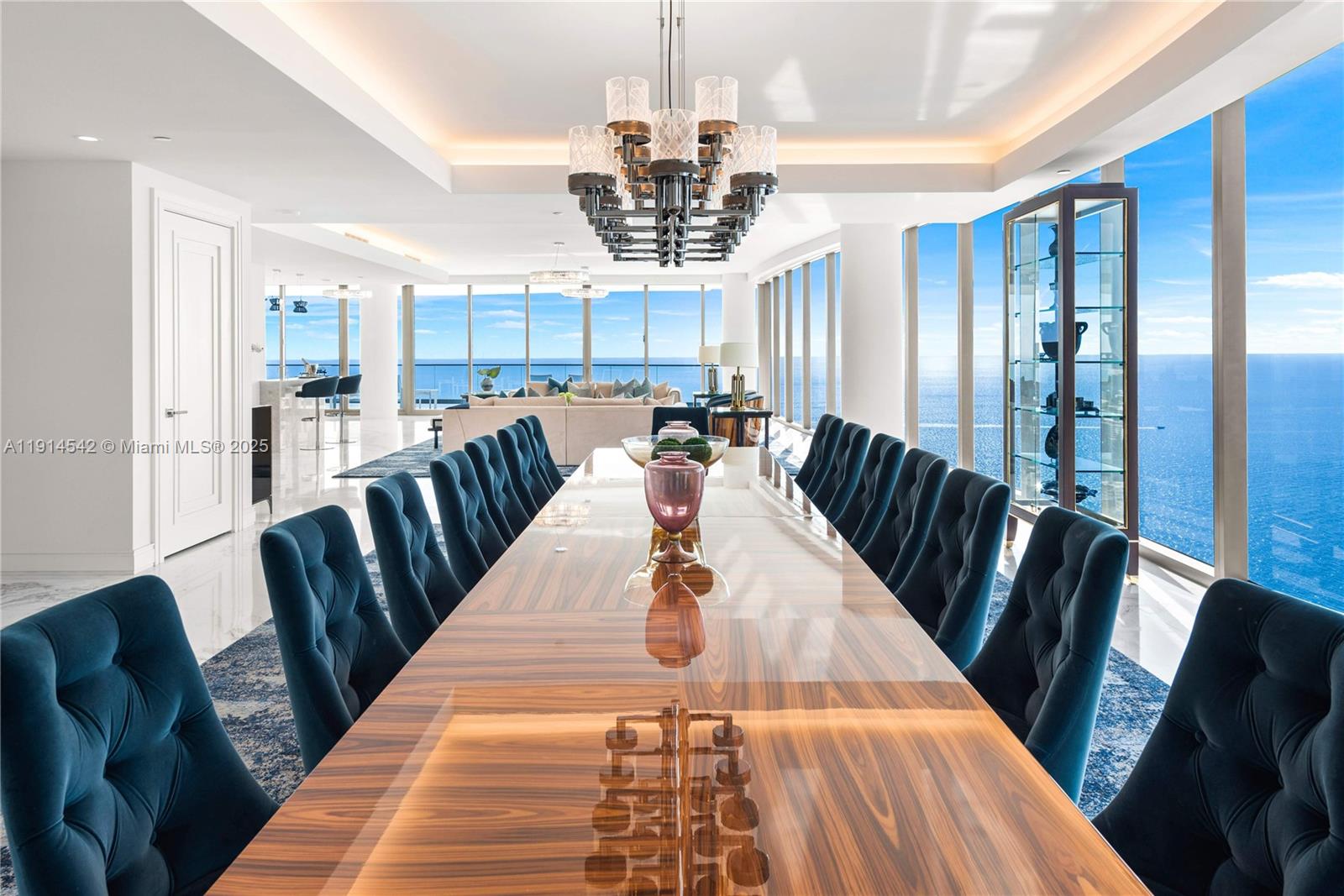 17901 Collins Avenue, Unit TS3405/07 Sunny Isles Beach, FL 33160 - Photo 11 of 47 a view of a dining room with furniture a chandelier and wooden floor