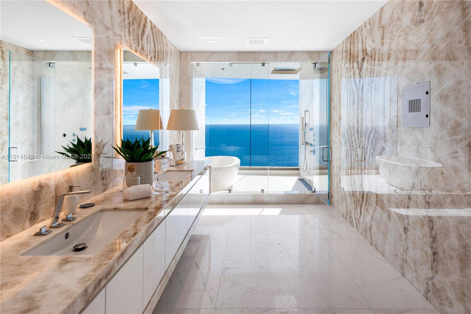 17901 Collins Avenue, Unit TS3405/07 Sunny Isles Beach, FL 33160 - Photo 17 of 47 a spacious bathroom with a tub sink and mirror