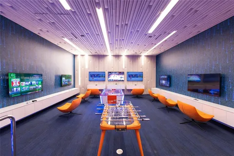 a room with painting on the wall and a large window