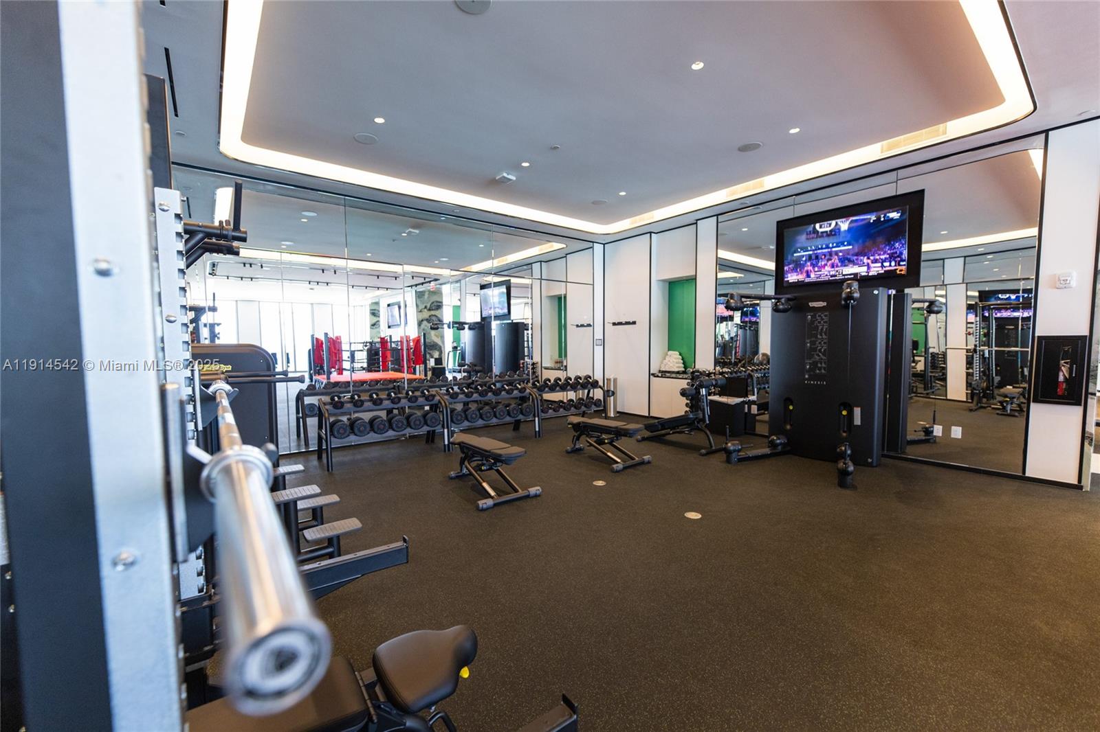 17901 Collins Avenue, Unit TS3405/07 Sunny Isles Beach, FL 33160 - Photo 32 of 47 a room with gym equipment and a flat screen tv