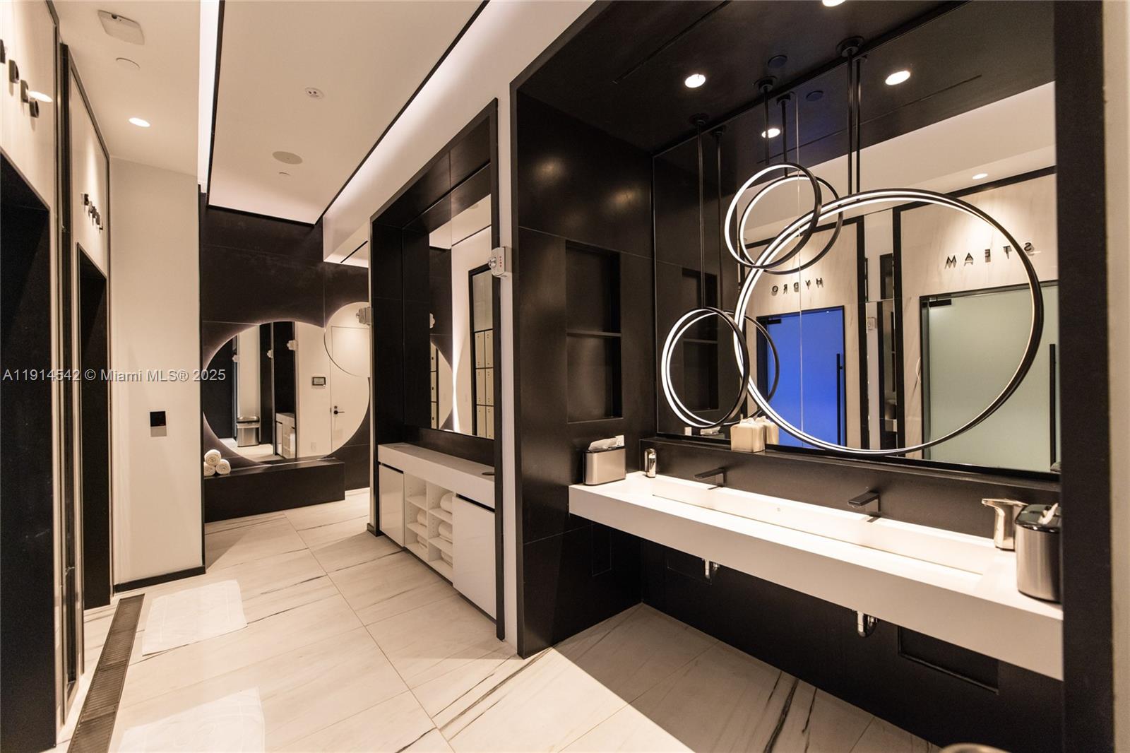 17901 Collins Avenue, Unit TS3405/07 Sunny Isles Beach, FL 33160 - Photo 37 of 47 a bathroom with a sink a toilet and a mirror