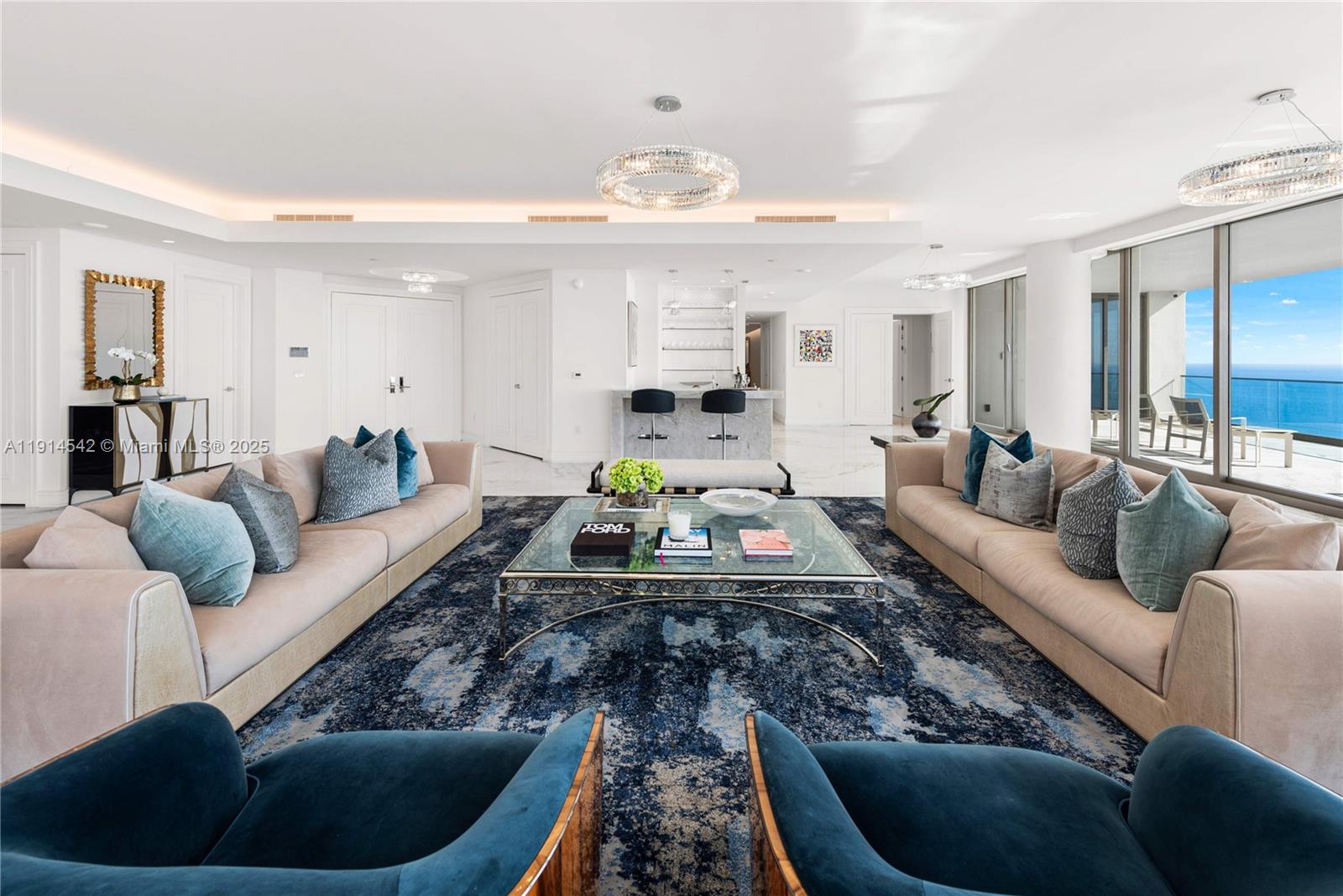 17901 Collins Avenue, Unit TS3405/07 Sunny Isles Beach, FL 33160 - Photo 10 of 47 a living room with furniture and a chandelier