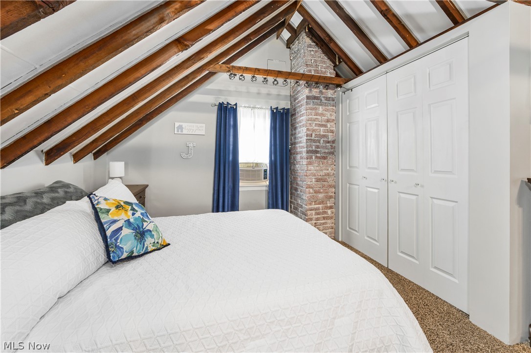 322 Valleyview Avenue Northwest Canton, OH 44708 - Photo 22 of 35 Carpeted bedroom featuring vaulted ceiling with beams and brick wall