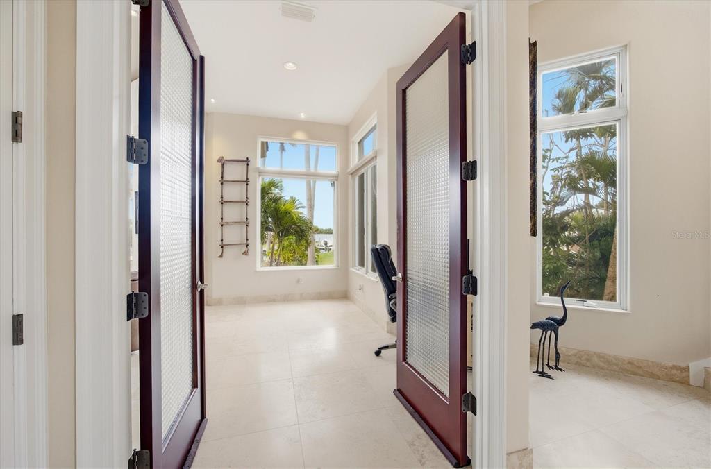 761 Norton Street Longboat Key, FL 34228 - Photo 11 of 66 a view of a hallway with windows and refrigerator