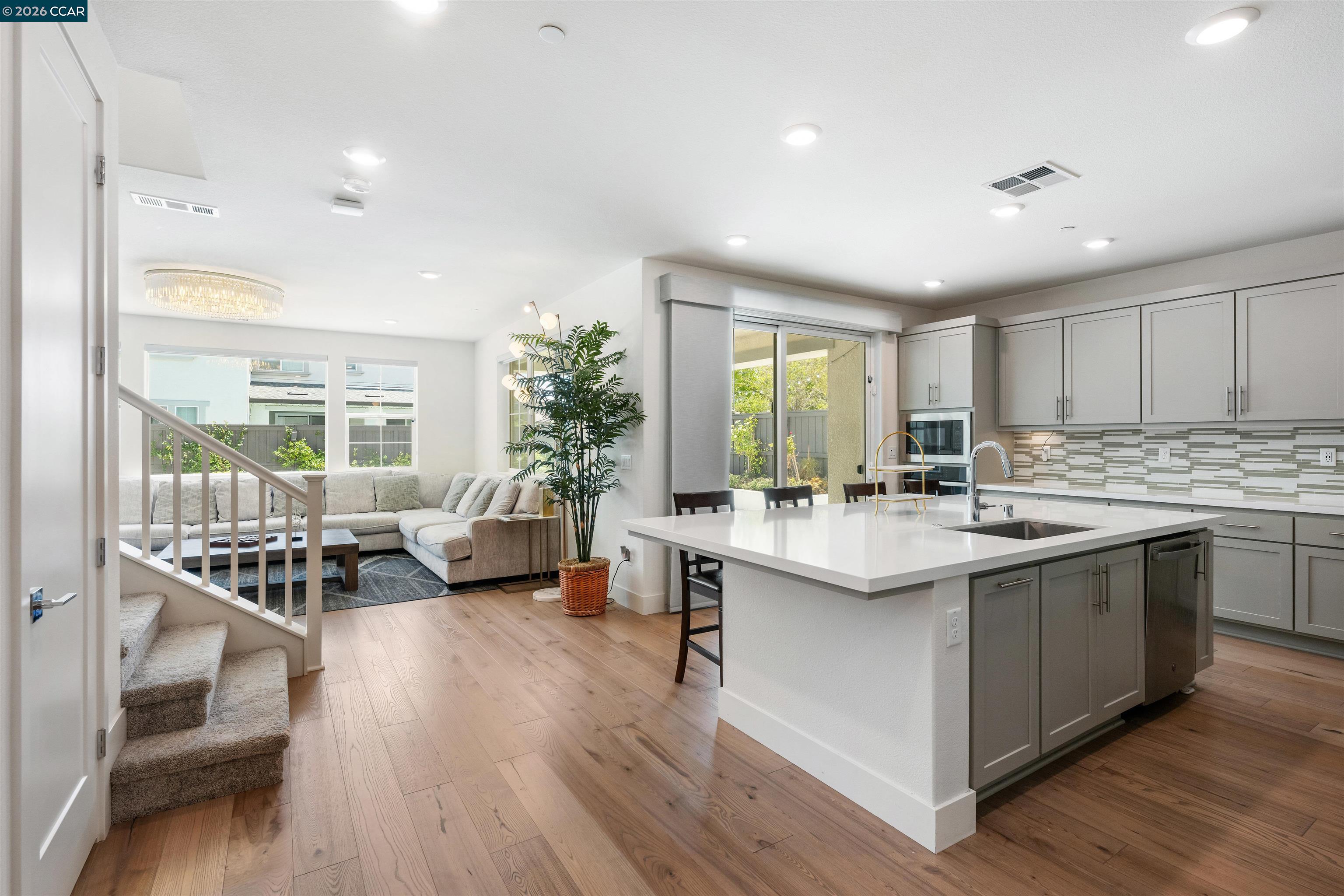 6274 Carousel Avenue Tracy, CA 95377 - Photo 11 of 46 a kitchen with counter top space sink stove and wooden floor