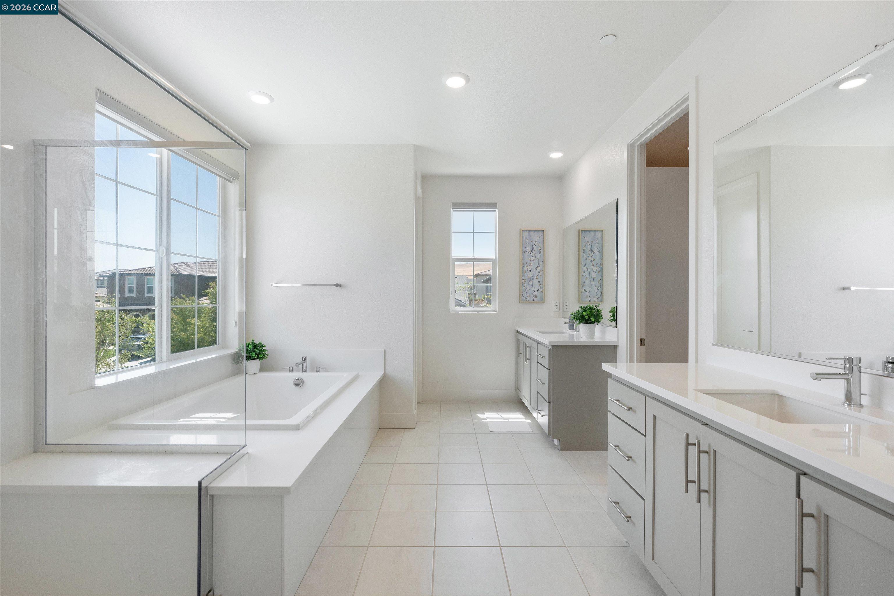 6274 Carousel Avenue Tracy, CA 95377 - Photo 26 of 46 a bathroom with a sink a bathtub a mirror a vanity and a shower