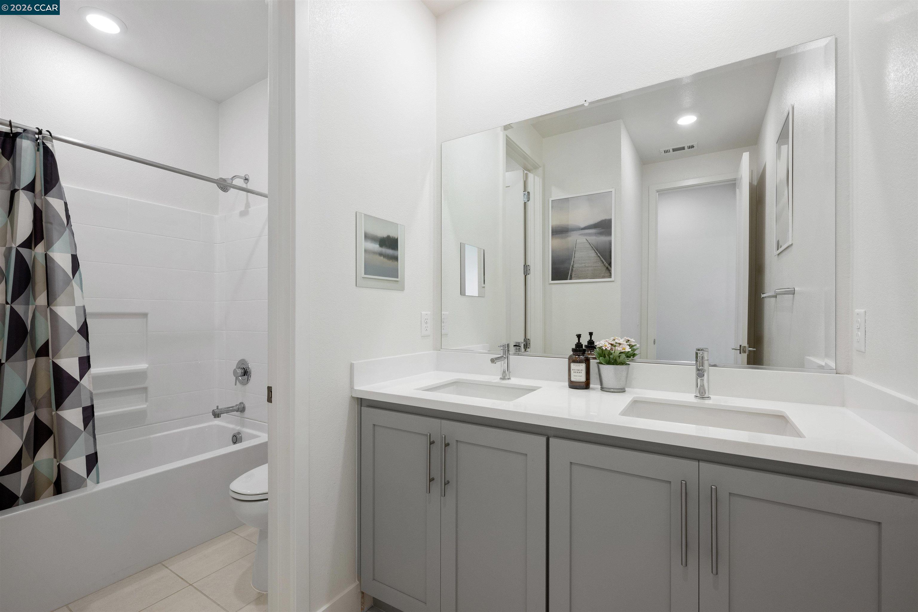 6274 Carousel Avenue Tracy, CA 95377 - Photo 35 of 46 a bathroom with a tub a sink and a mirror