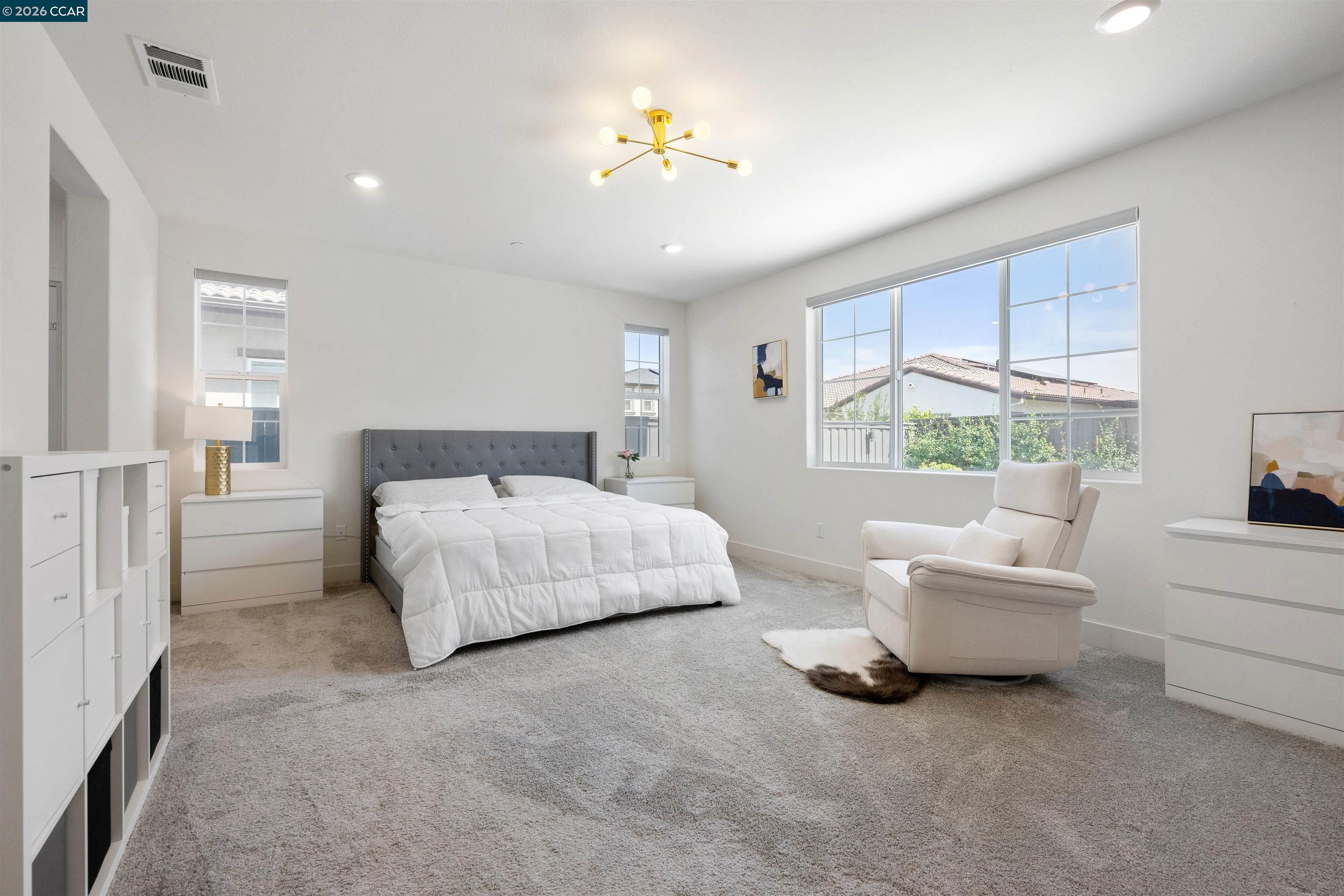 6274 Carousel Avenue Tracy, CA 95377 - Photo 37 of 46 a bedroom with a bed and a chandelier