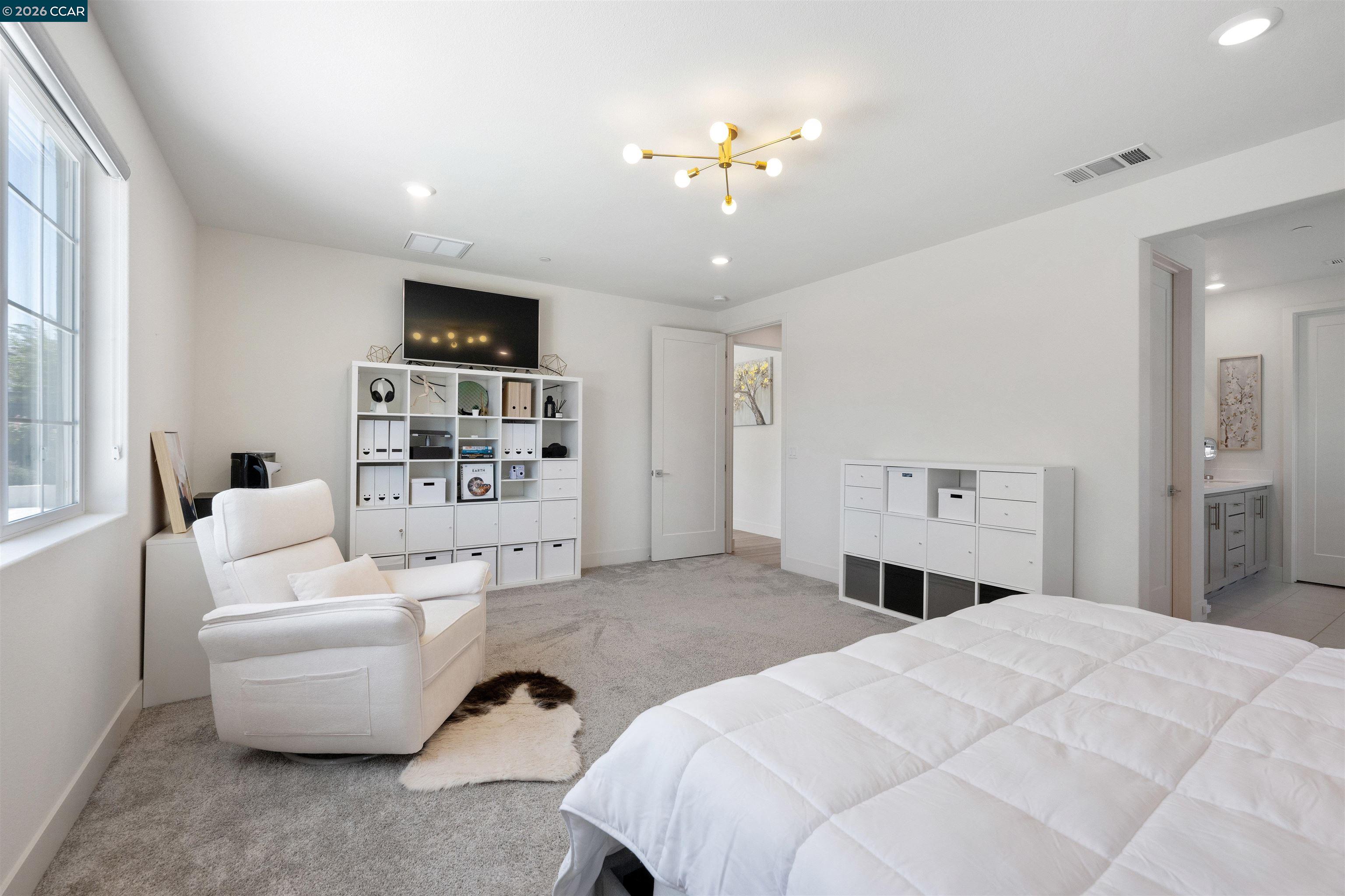 6274 Carousel Avenue Tracy, CA 95377 - Photo 39 of 46 a spacious bedroom with a bed and a couch