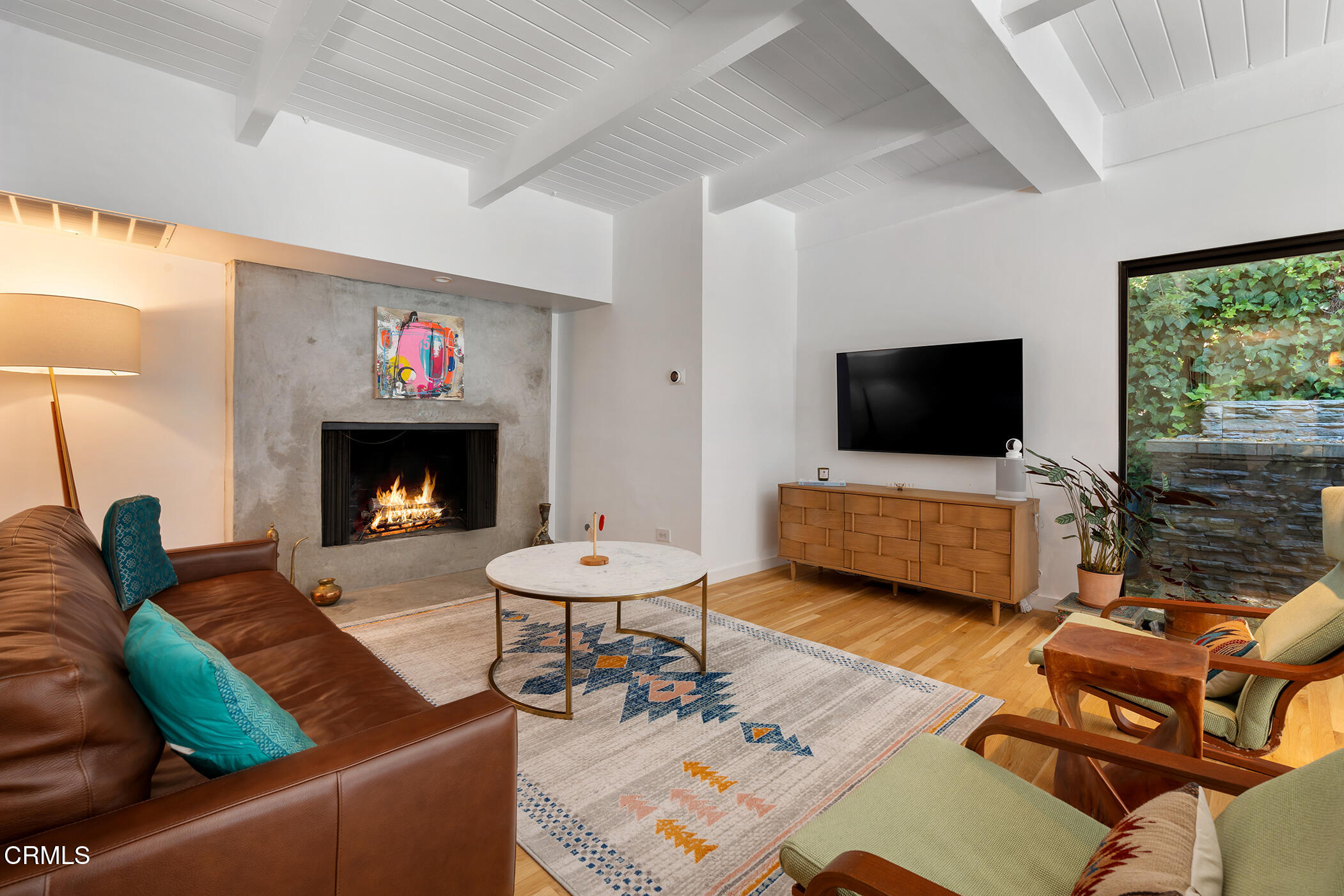 3581 Valley Meadow Road Sherman Oaks, CA 91403 - Photo 16 of 30 a living room with furniture a flat screen tv and a fireplace