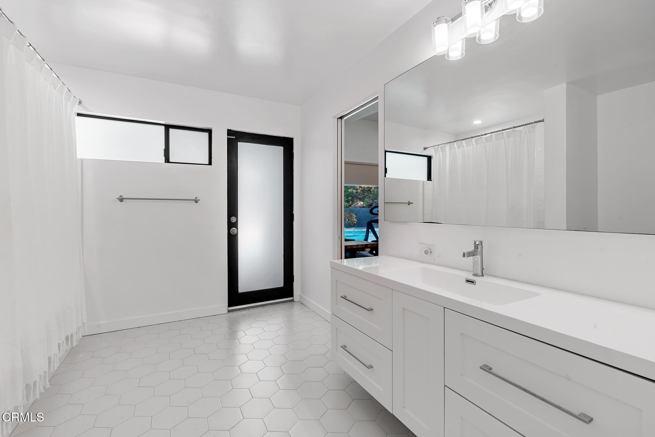 3581 Valley Meadow Road Sherman Oaks, CA 91403 - Photo 18 of 30 a spacious bathroom with a shower a sink and mirror
