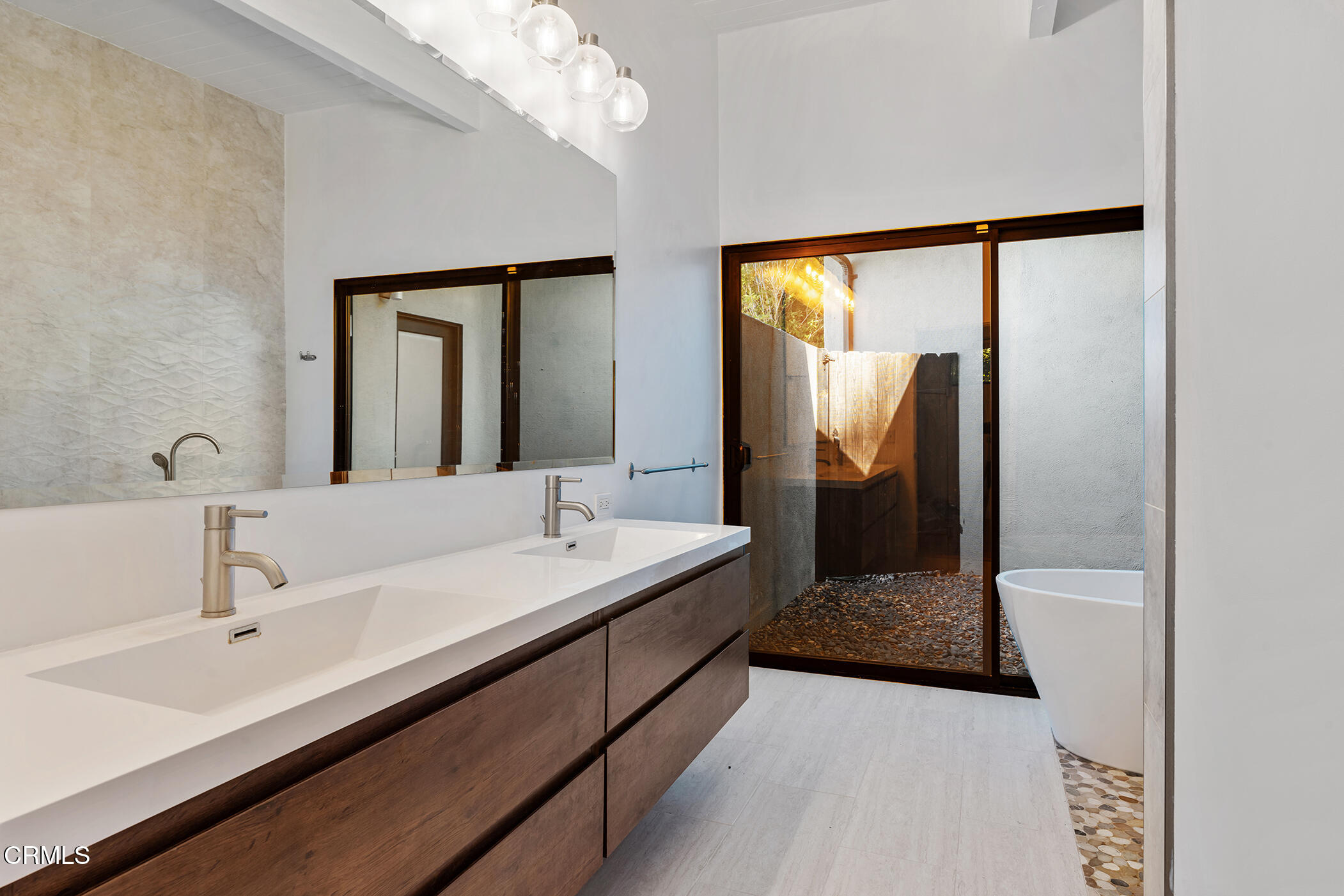 3581 Valley Meadow Road Sherman Oaks, CA 91403 - Photo 27 of 30 a en suite bathroom with a double vanity sink and mirror