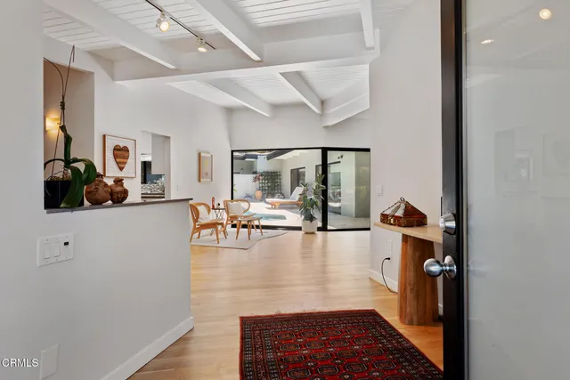 a view of living room with furniture and wooden floor