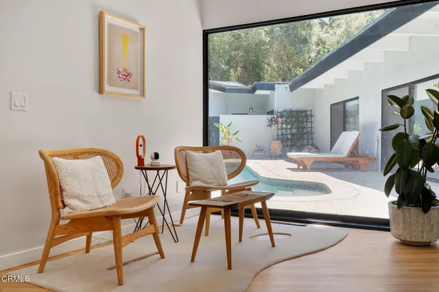 a workspace with furniture and a large window