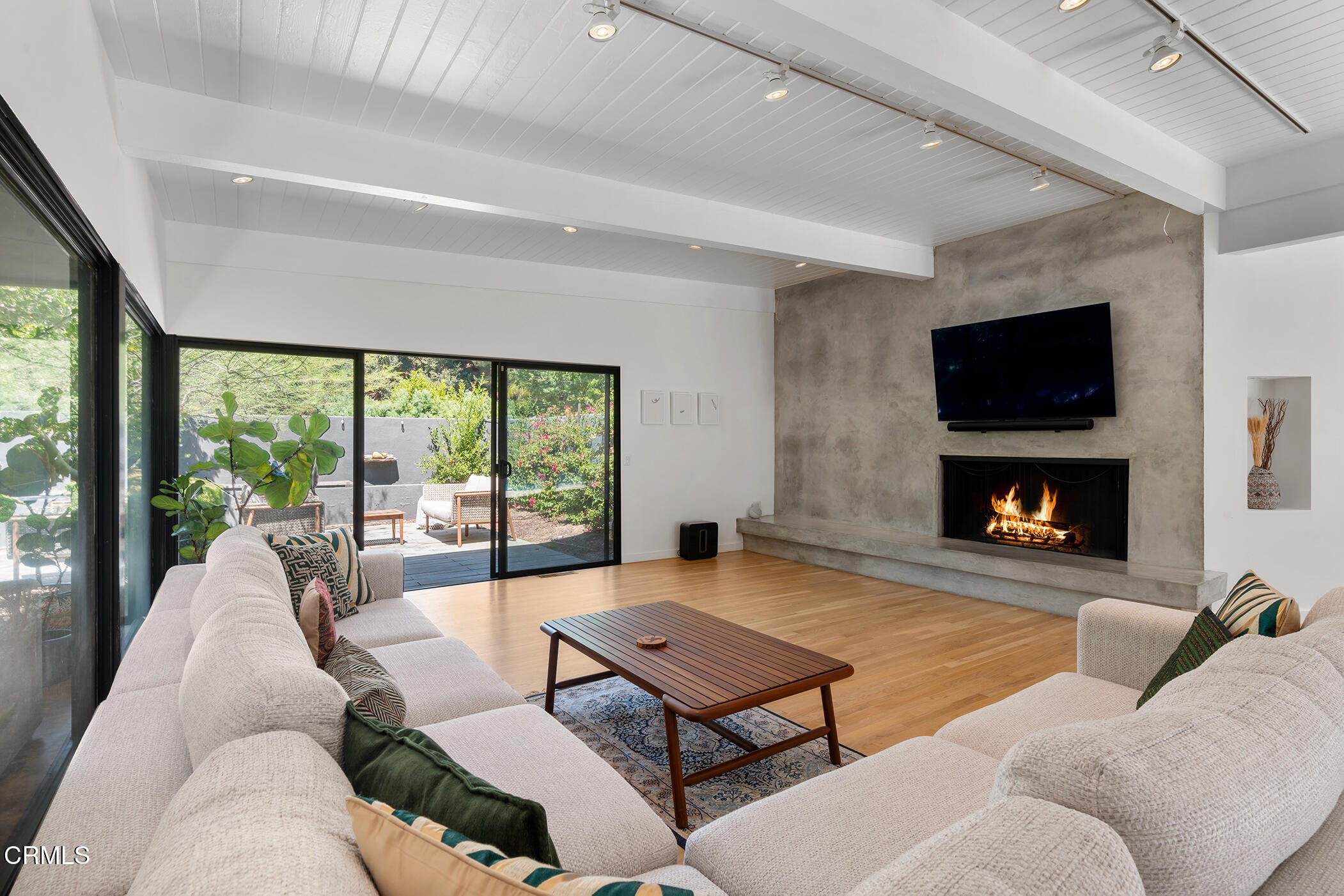 3581 Valley Meadow Road Sherman Oaks, CA 91403 - Photo 6 of 30 a living room with furniture a flat screen tv and a fireplace