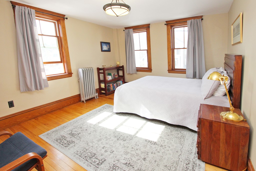 346 Merrimac Street Newburyport, MA 01950 - Photo 15 of 30 a bedroom with a bed and wooden floor