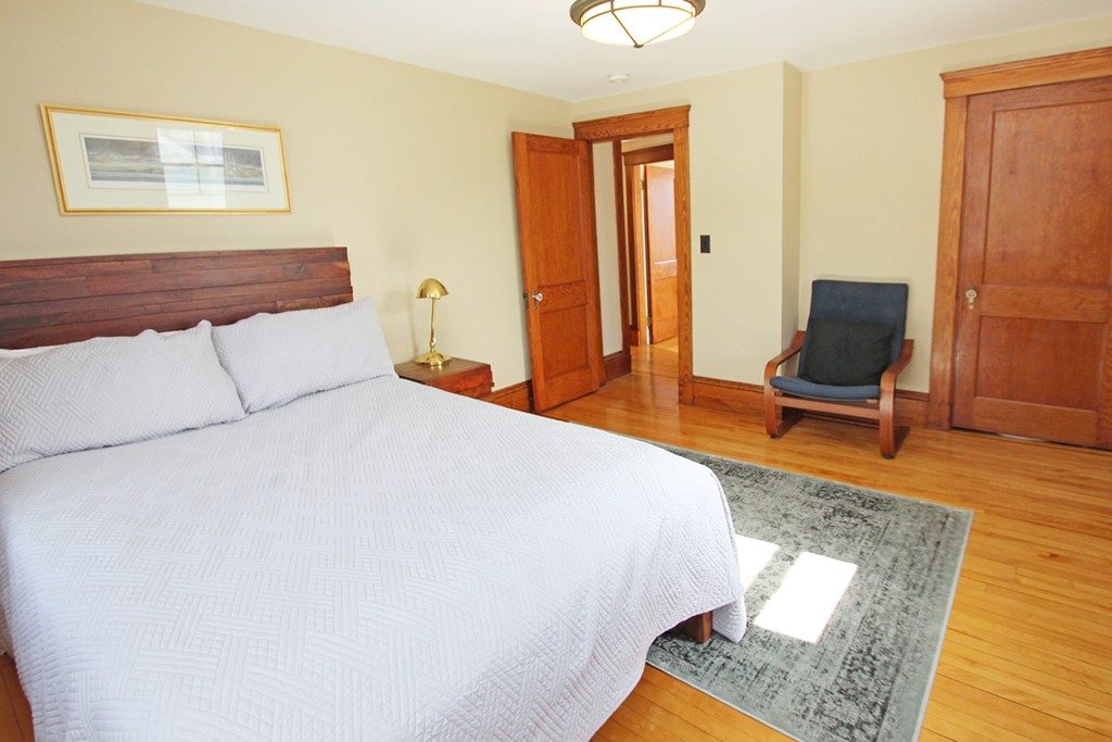 346 Merrimac Street Newburyport, MA 01950 - Photo 16 of 30 a bedroom with a bed and wooden floor