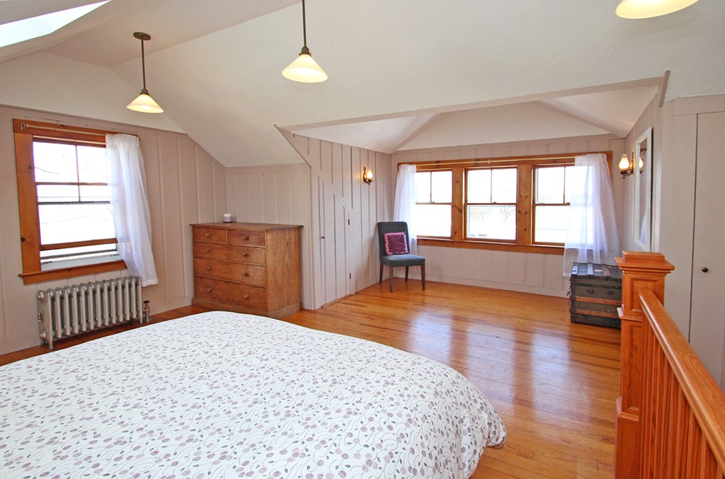 346 Merrimac Street Newburyport, MA 01950 - Photo 20 of 30 a bedroom with a bed and wooden floor