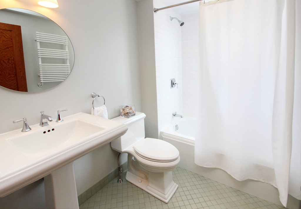 346 Merrimac Street Newburyport, MA 01950 - Photo 23 of 30 a bathroom with a sink a toilet and mirror