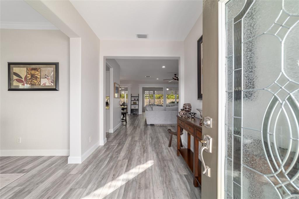 11888 Southeast 91st Circle Summerfield, FL 34491 - Photo 11 of 67 a view of a hallway with a dining table & chairs