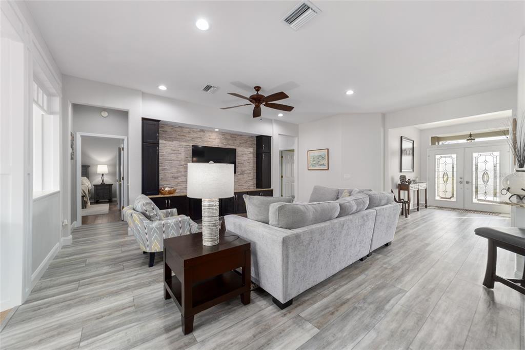 11888 Southeast 91st Circle Summerfield, FL 34491 - Photo 20 of 67 a living room with furniture and a wooden floor