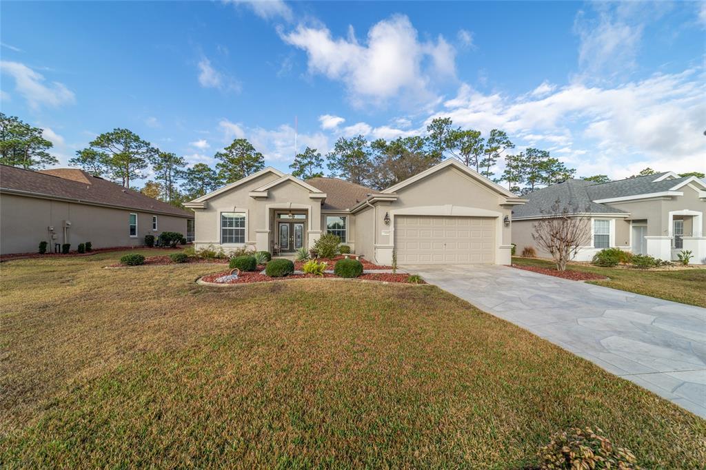 11888 Southeast 91st Circle Summerfield, FL 34491 - Photo 2 of 67 a front view of a house with yard and green space