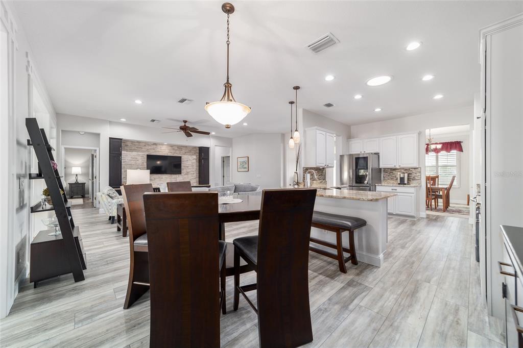 11888 Southeast 91st Circle Summerfield, FL 34491 - Photo 25 of 67 a view of a dining room and livingroom with furniture wooden floor a rug a fireplace