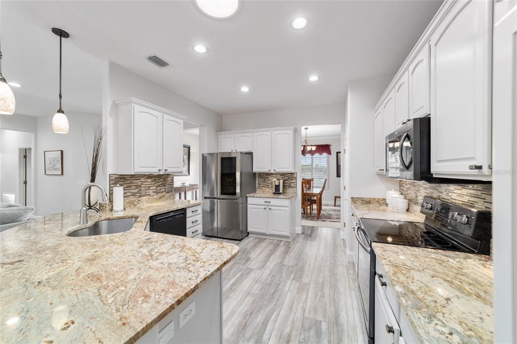 11888 Southeast 91st Circle Summerfield, FL 34491 - Photo 28 of 67 a large kitchen with stainless steel appliances lots of counter top space refrigerator and cabinets