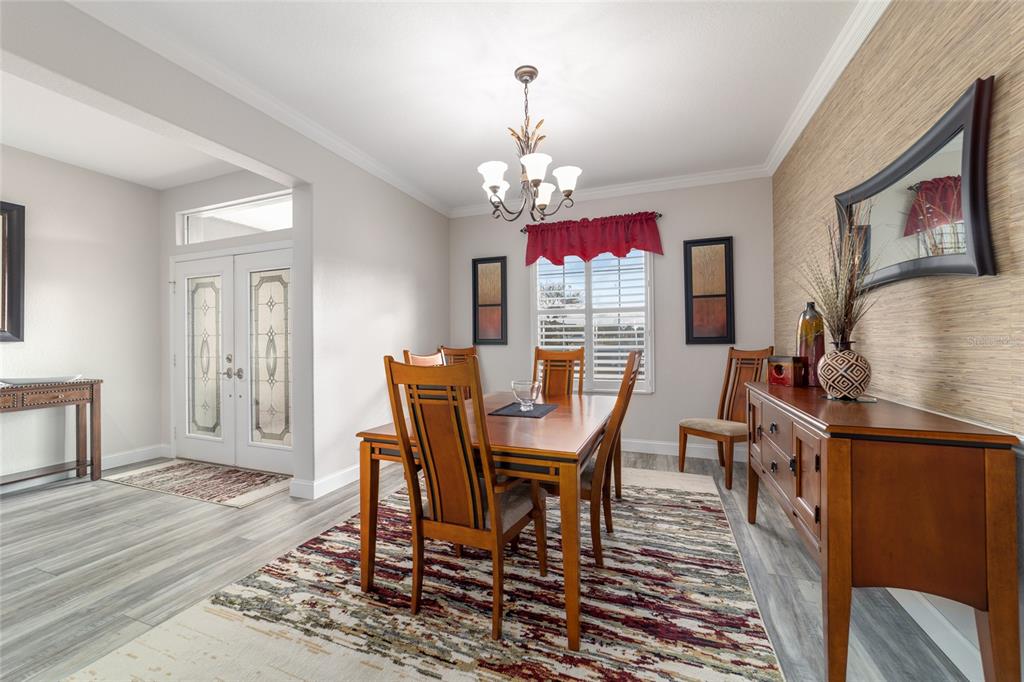 11888 Southeast 91st Circle Summerfield, FL 34491 - Photo 33 of 67 a view of a dining room with furniture a chandelier and wooden floor