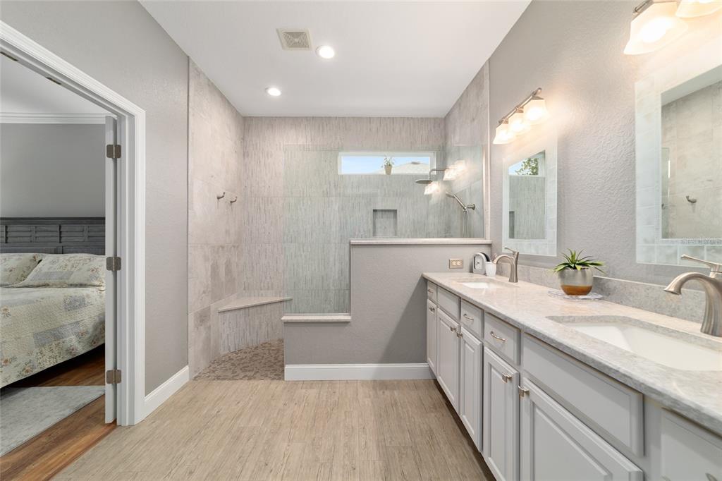 11888 Southeast 91st Circle Summerfield, FL 34491 - Photo 41 of 67 a bathroom with a double vanity sink and mirror with shower