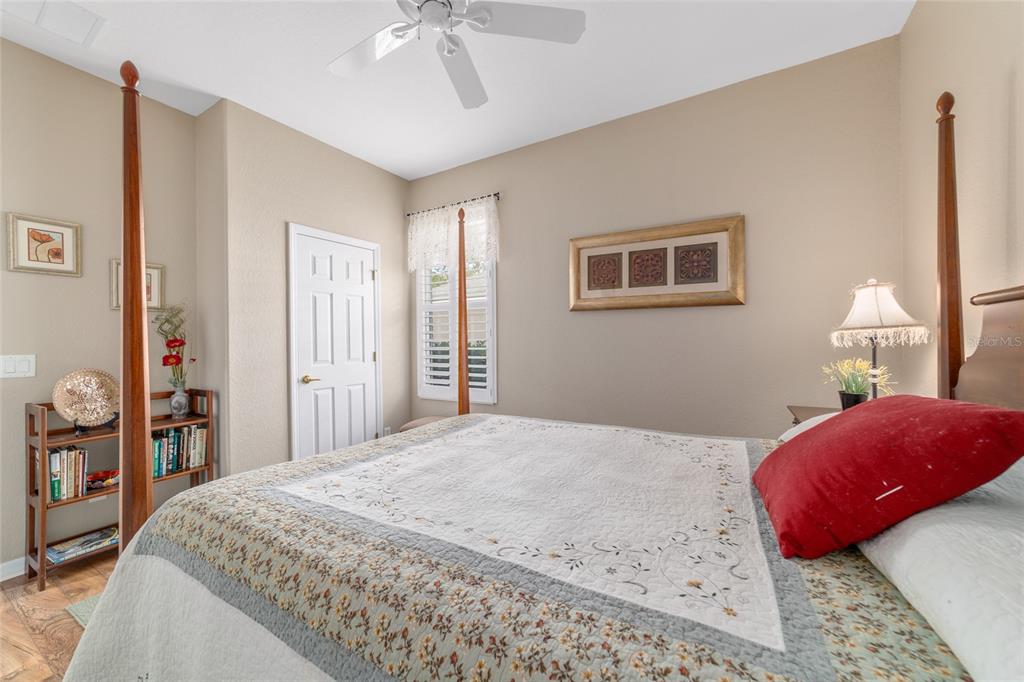 11888 Southeast 91st Circle Summerfield, FL 34491 - Photo 44 of 67 a bedroom with a bed and a chandelier