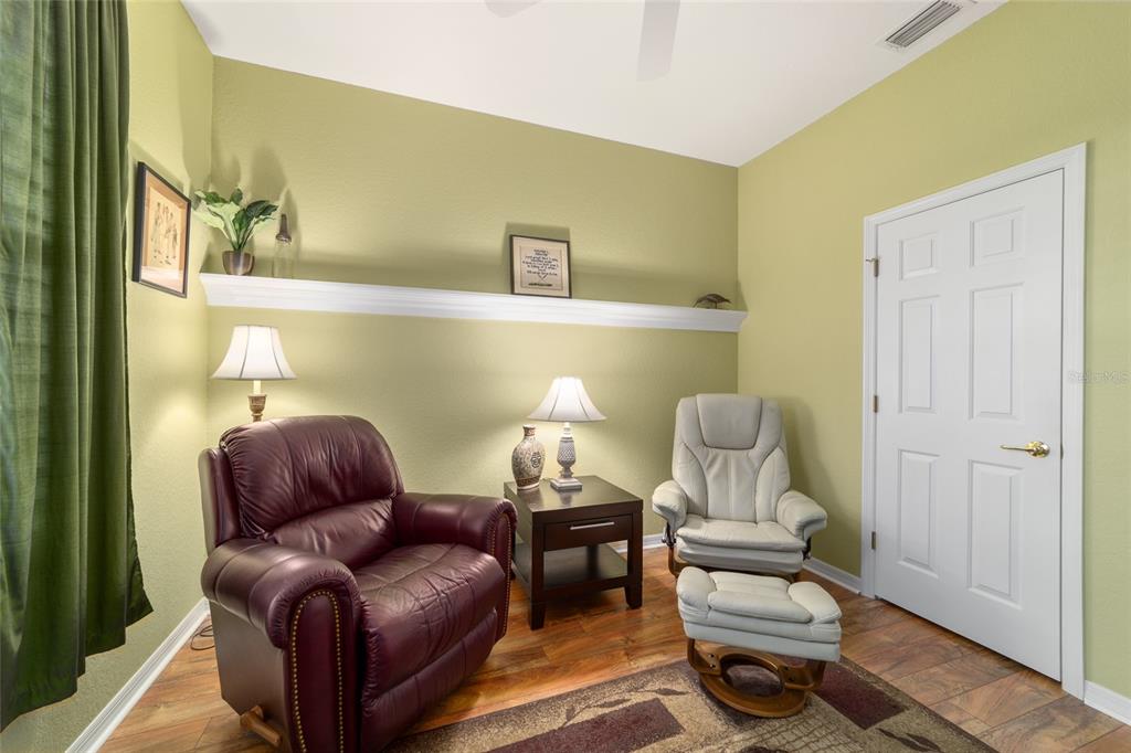 11888 Southeast 91st Circle Summerfield, FL 34491 - Photo 48 of 67 a living room with furniture and a lamp