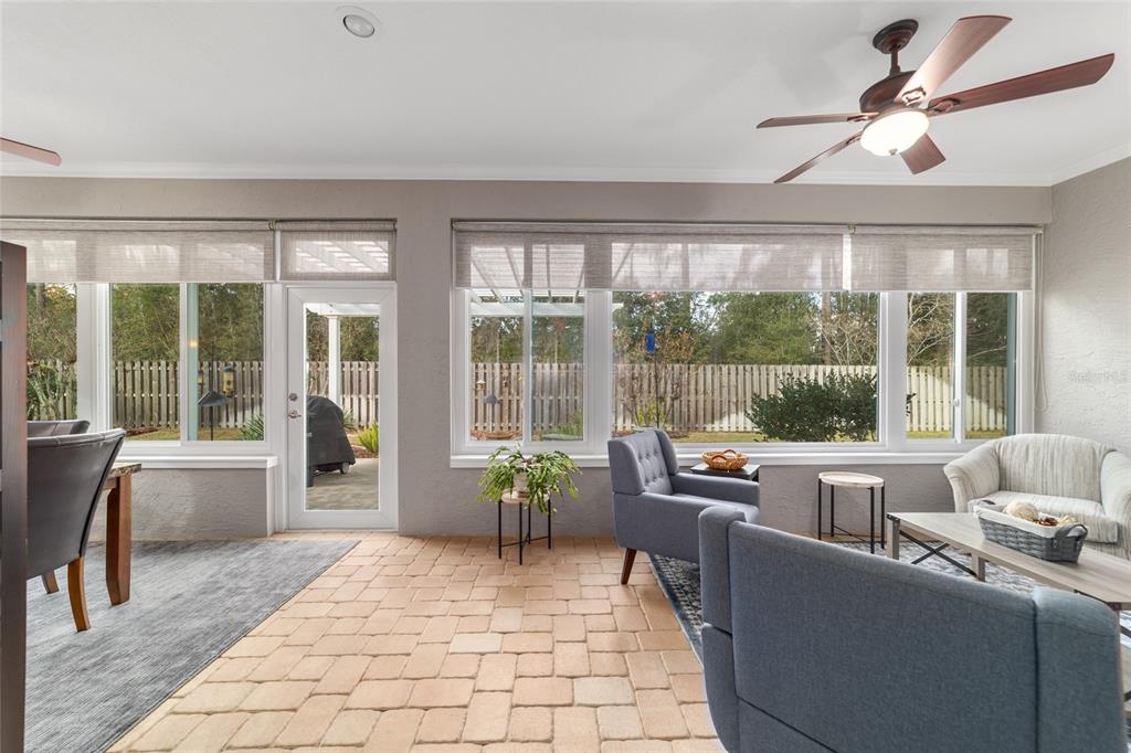 11888 Southeast 91st Circle Summerfield, FL 34491 - Photo 52 of 67 a living room with furniture and a large window with garden view