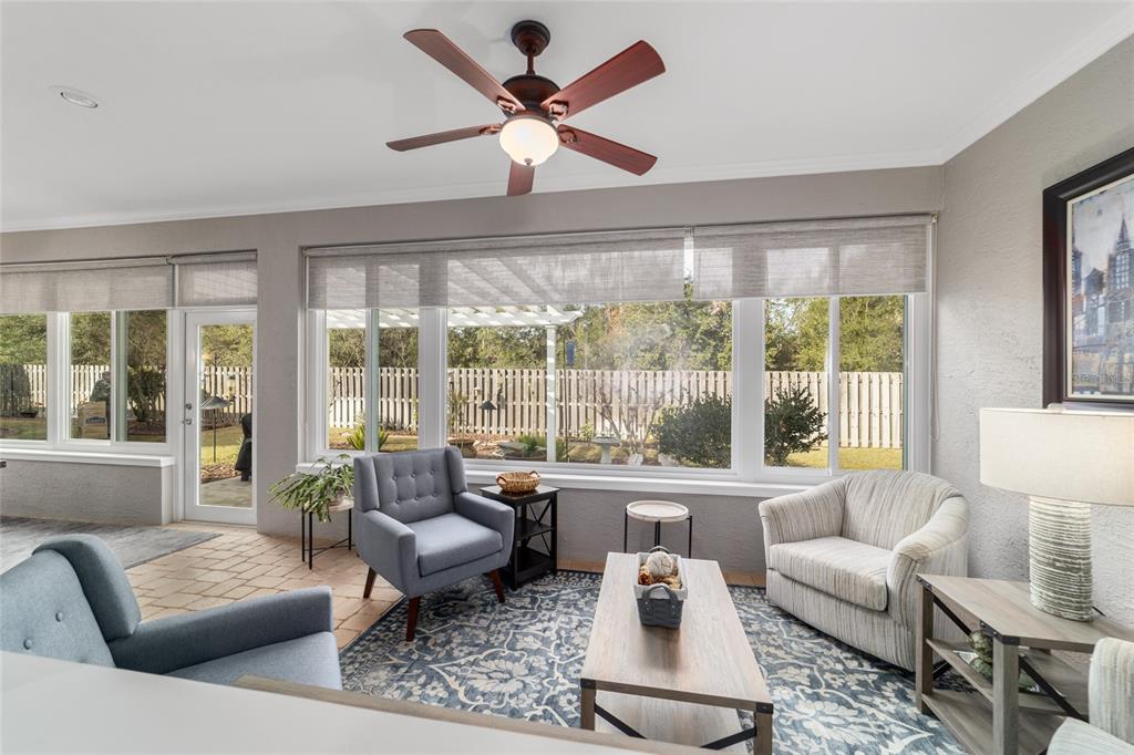 11888 Southeast 91st Circle Summerfield, FL 34491 - Photo 53 of 67 a living room with furniture and a large window with garden view