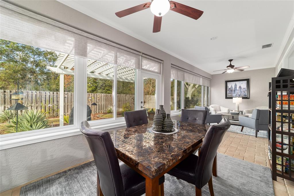 11888 Southeast 91st Circle Summerfield, FL 34491 - Photo 56 of 67 a dining room with furniture a chandelier and wooden floor