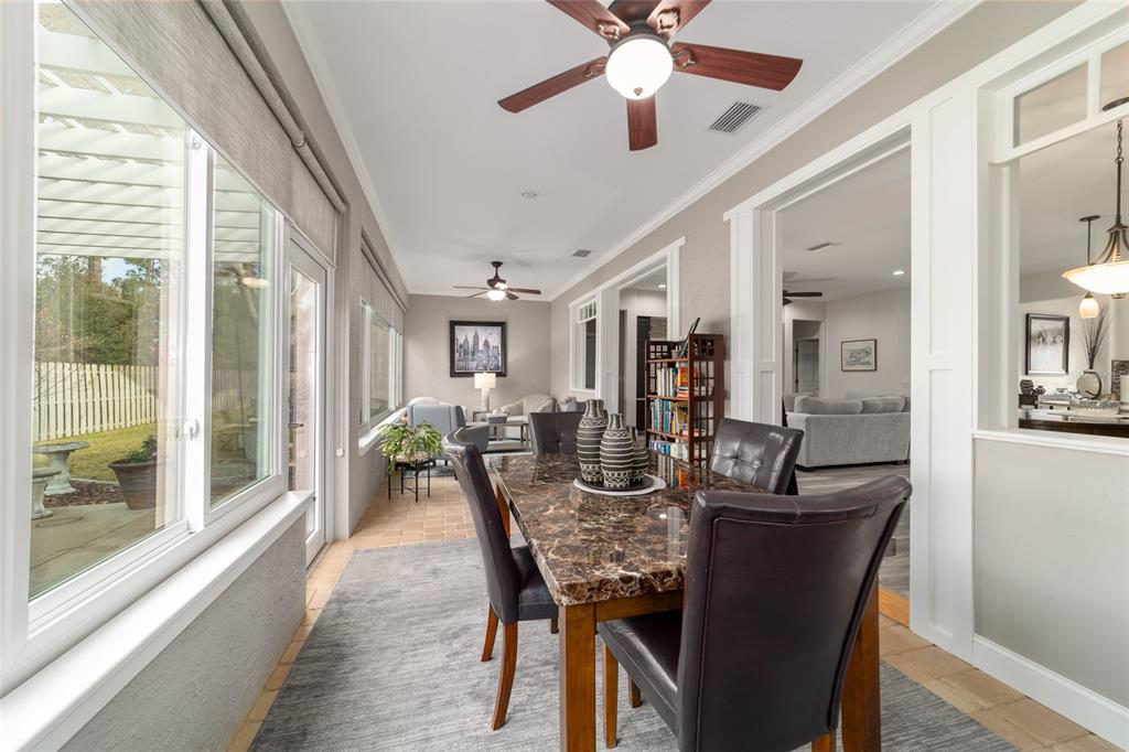 11888 Southeast 91st Circle Summerfield, FL 34491 - Photo 57 of 67 a dining room with furniture a potted plant and a chandelier