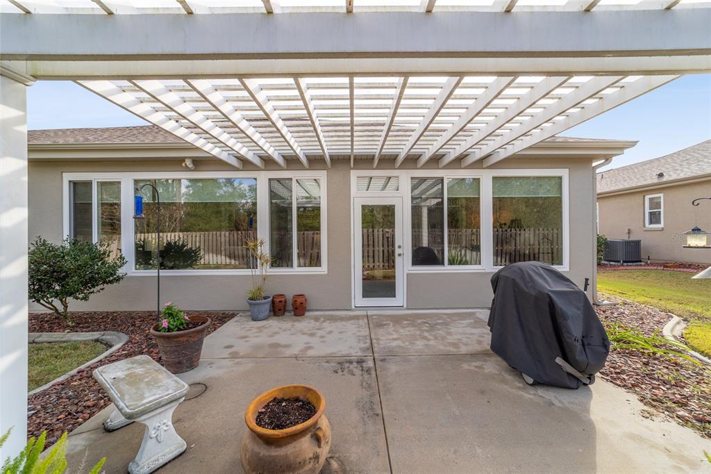 11888 Southeast 91st Circle Summerfield, FL 34491 - Photo 60 of 67 a view of a porch with furniture and floor to ceiling window