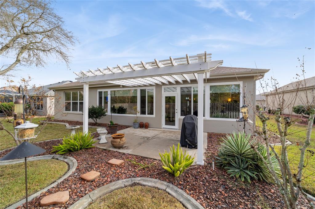 11888 Southeast 91st Circle Summerfield, FL 34491 - Photo 63 of 67 a view of a house with backyard sitting area and porch