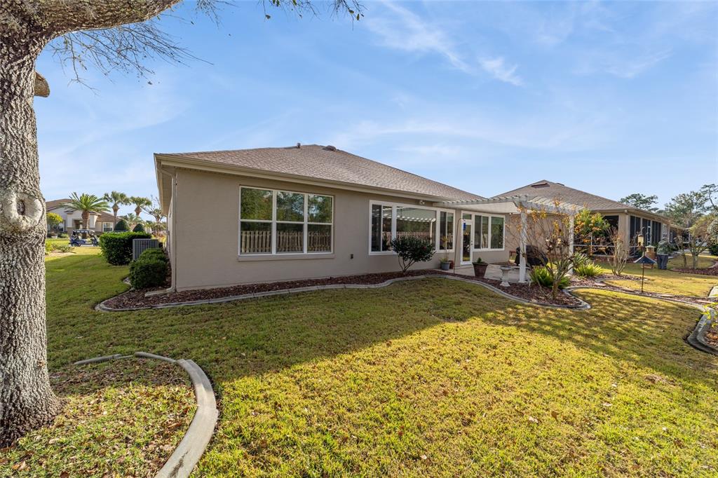 11888 Southeast 91st Circle Summerfield, FL 34491 - Photo 65 of 67 a view of a house with swimming pool and a yard