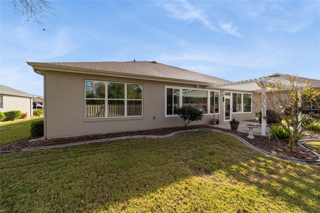 11888 Southeast 91st Circle Summerfield, FL 34491 - Photo 66 of 67 a view of a house with backyard sitting area and garden
