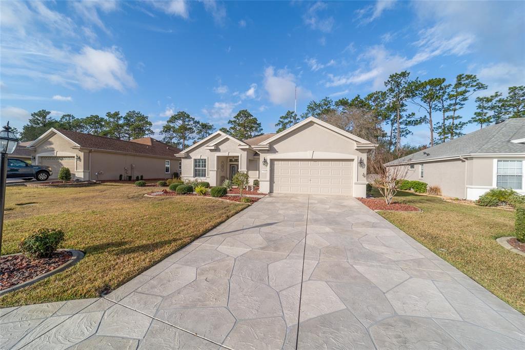 11888 Southeast 91st Circle Summerfield, FL 34491 - Photo 8 of 67 a view of house with yard and large tree in front of it