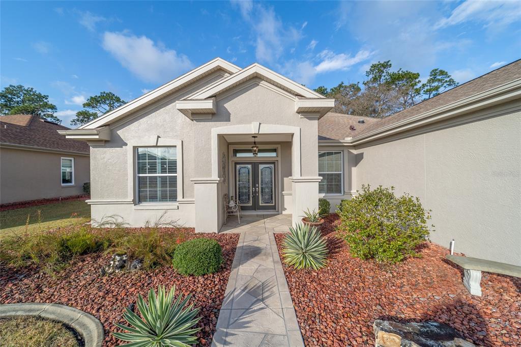 11888 Southeast 91st Circle Summerfield, FL 34491 - Photo 10 of 67 a front view of a house with a yard
