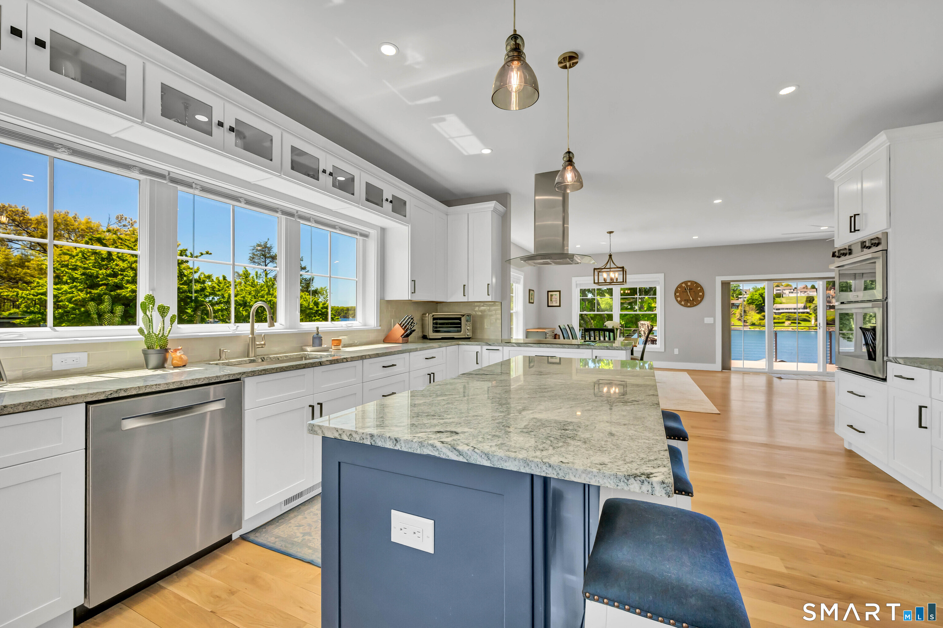 21 Lakeview Road Brookfield, CT 06804 - Photo 7 of 39 a kitchen with stainless steel appliances granite countertop a sink a stove and a wooden floors