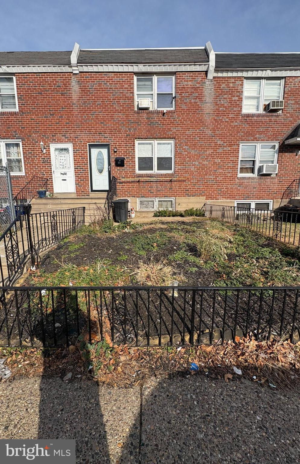 a view of a brick house with a yard