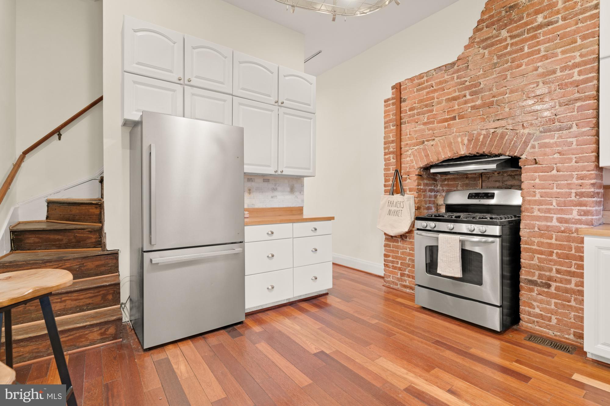 2133 Bolton Street Baltimore, MD 21217 - Photo 16 of 53 a kitchen with white cabinets and white appliances
