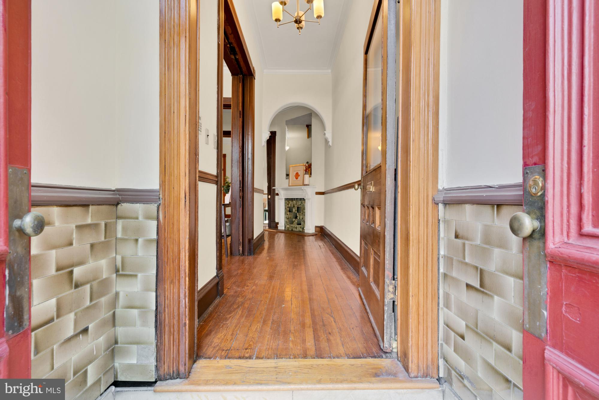 2133 Bolton Street Baltimore, MD 21217 - Photo 2 of 53 a view of a hallway with wooden floor and staircase