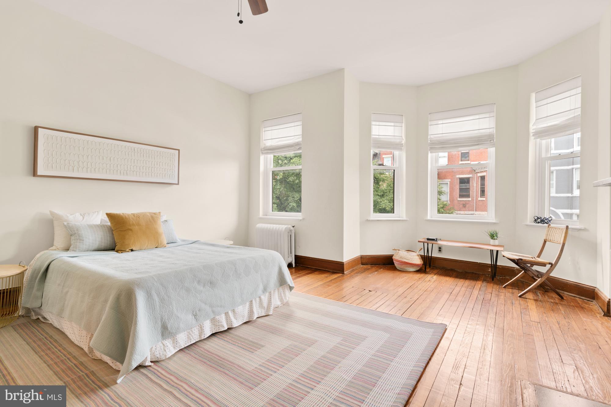 2133 Bolton Street Baltimore, MD 21217 - Photo 21 of 53 a bedroom with a bed and wooden floor
