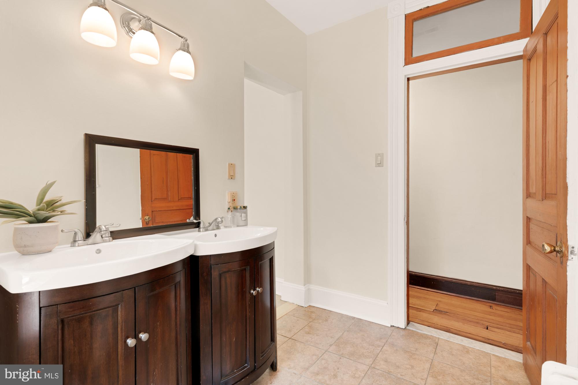 2133 Bolton Street Baltimore, MD 21217 - Photo 25 of 53 a bathroom with a sink a mirror and a vanity