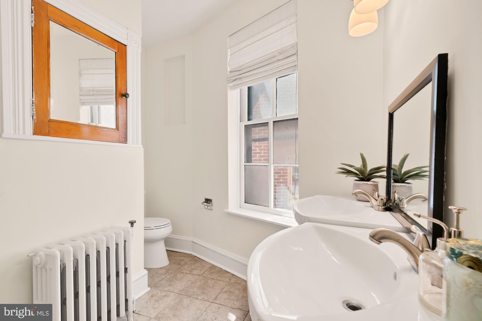 2133 Bolton Street Baltimore, MD 21217 - Photo 26 of 53 a bathroom with a sink and a large mirror